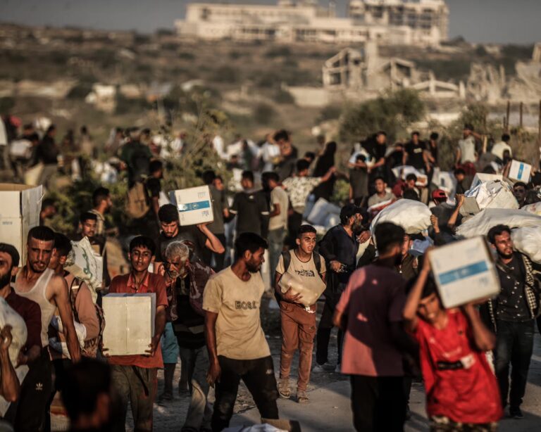 Palestinians receive aid supplies after aid trucks enter through Netzarim Corridor in the Gaza strip. Photograph: Anadolu/Getty Images